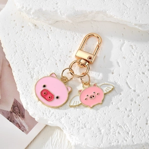 Pink flying pig keychain with golden plating and enamel charms for bags and gifts