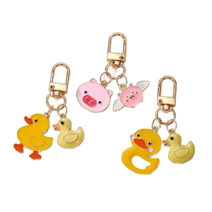 Cartoon yellow duck and flying pig alloy keychains set with gold lobster clasps