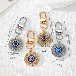 Detailed view of Evil Eye keychains with rhinestone embellishments and sizing dimensions