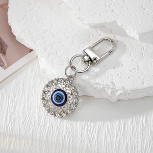 Detail of evil eye keychain with blue enamel center and sparkling rhinestones