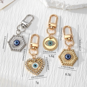 Detail of assorted Evil Eye keychains in gold and silver finish with crystal accents