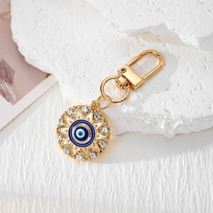 Golden Evil Eye keychain with sunburst frame and sparkling crystals for bags