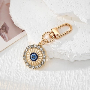 Golden Evil Eye keychain with blue Nazar charm and sparkling white rhinestones on stones