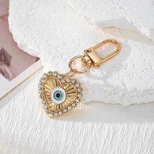 Golden heart keychain featuring Turkish evil eye design and sparkling rhinestones