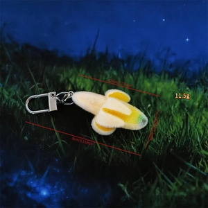 Close-up of plush banana keychain with detailed size parameters and silver spring clip