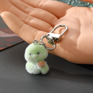 Cute light green plush snake keychain with a soft flocked texture and silver lobster clasp