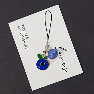 Detail of blueberry resin charm with blue metal drop oil leaf pendant on phone strap