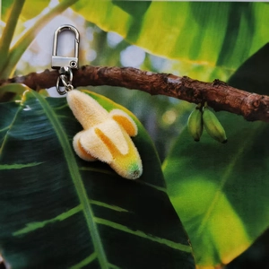 Cute flocked peeling banana plush keychain with metal U-shaped buckle on plant branch