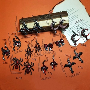 Gothic silver earrings set with spider, moon and red gemstone details for Halloween