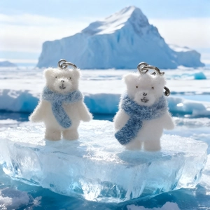 Fluffy polar bear keychain with blue scarf on ice block for bags and gifts