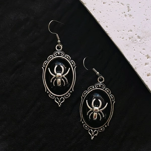 Gothic silver spider earrings with black oval frames and vintage dark aesthetic design