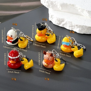Detailed view of assorted resin cartoon duck keychains with precise size and weight specs
