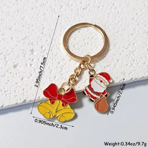 Detail of Christmas Santa keychain with yellow bells showing dimensions and colorful enamel
