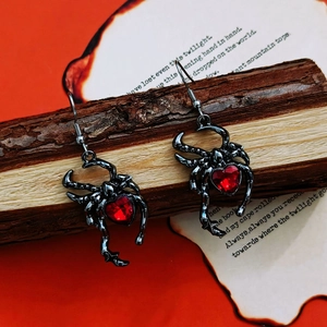 Gothic spider moon earrings with red heart gemstone on dark vintage background