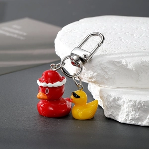 Macro shot of resin cartoon duck pendants with Christmas hat and sunglasses keychain