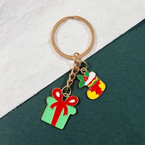Detail of Christmas keychain featuring enamel gift box and holiday stocking pendants