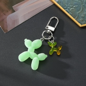 Detail of flocking green balloon dog keychain with glitter resin charm and silver clasp