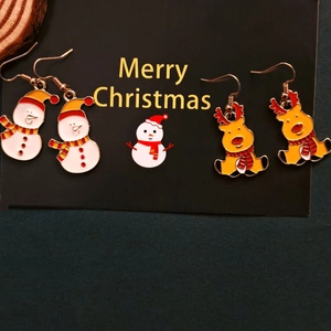 Christmas earrings set with enamel snowman and reindeer charms on gold metal hooks