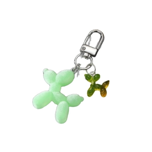 Luminous flocked balloon dog keychain in macaron green with glitter resin charm detail