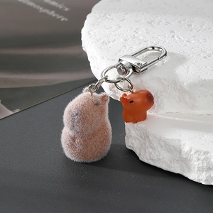 Flocked Capybara keychain with small resin charm on silver metal ring and D-clasp