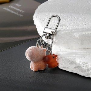 Flocked capybara keychain with resin mini charm on a metallic ring with silver hook