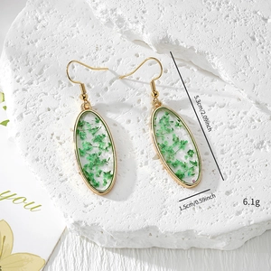 Oval handmade earrings with real green dried flowers in resin and gold frame hooks