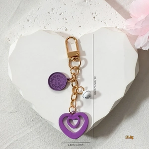 Pink heart keychain with gold coin charm and bell accessory for fashion bags