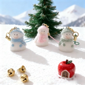 Three colorful flocked snowman phone charms in blue, pink, and green with golden hooks