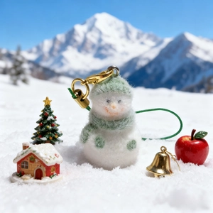 Cute snowman plush phone strap with green hat and scarf on a snowy mountain background