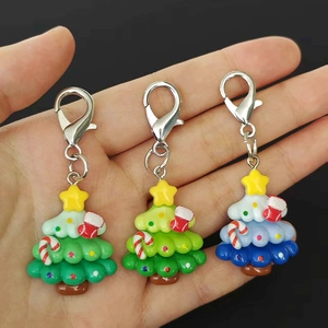 Colorful resin Christmas tree keychains in green and blue with star and holiday ornaments