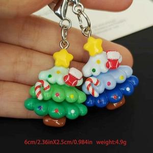 Detail showing green and blue resin Christmas tree keychains with colorful decorations