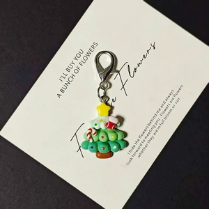 Detailed shot of Christmas tree keychain with colorful enamel socks and lobster clasp
