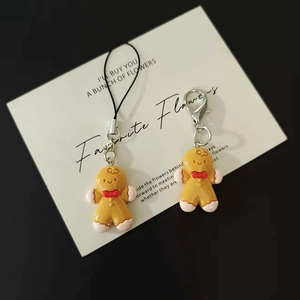 Handmade gingerbread man bag charms with red bow and lobster clasp for Christmas gifts