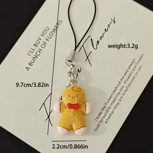 Detail of gingerbread man charm with red bow and secure silver lobster clasp