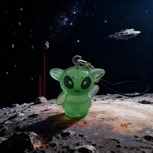 Luminous green resin alien charm showing dimensions of 3.7cm height and 2.4cm width