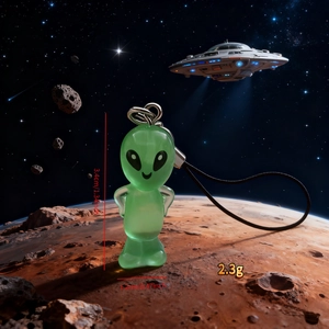 Detailed size view of green resin alien pendant with metallic ring and black cord