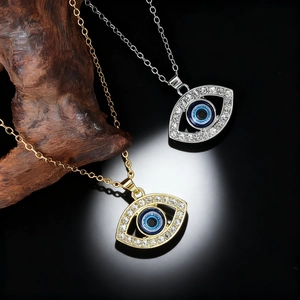 Set of gold and silver Evil Eye necklaces with sparkling zircons on a dark aesthetic background