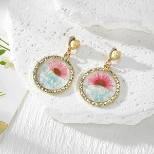 Elegant gold heart earrings with pink dried flowers and crushed stones in resin drops