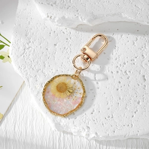 Irregular resin keychain with real yellow dried daisy flower and gold lobster clasp