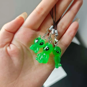Three-piece set of luminous green resin alien phone charms with black lanyards and lobster clips