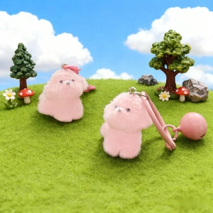 Pink plush puppy keychain with bell and bow decoration for bags and phones