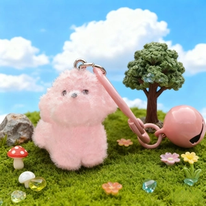 Cute pink plush puppy keychain with a large bell in a creative miniature garden scene