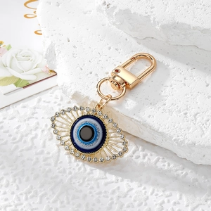 Detail of golden Evil Eye keychain with sparkling crystals and lobster clasp