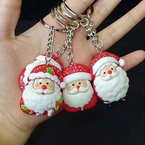Three cute PVC Santa Claus cartoon keychains with silver metal rings and red colors