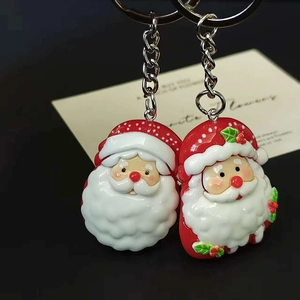 Pair of large Santa Claus keychains with red festive charms and metal rings