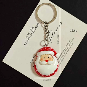 Detailed view of Santa Claus keychain showing dimensions of 4.13 inch and soft resin texture