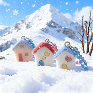 Cute flocked resin house charms on bead chains set against a snowy mountain backdrop
