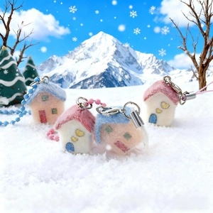 Handmade felt Christmas house phone charms with colorful roofs and snowy mountain scenery