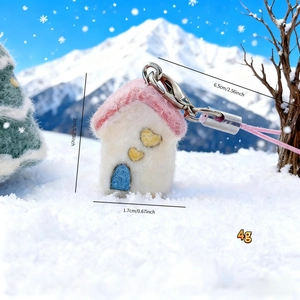 Detail view of handmade fleece house charm with size annotations and winter snow background