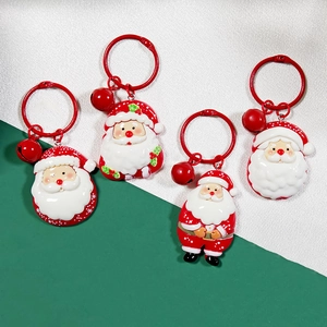 Set of four Santa Claus PVC keychains with red metal rings and festive bells